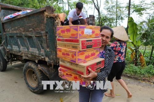 Niềm vui hiện rõ trên khuôn mặt người dân khi được nhận quà cứu trợ (ảnh chụp chiều ngày 7/8). Ảnh: Thành Đạt