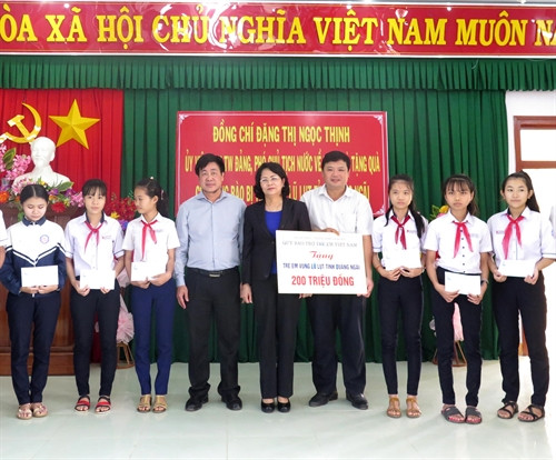 Phó Chủ tịch nước Đặng Thị Ngọc Thịnh tặng quà cho học sinh xã Đức Nhuận, huyện Mộ Đức. Ảnh: Phước Ngọc - TTXVN