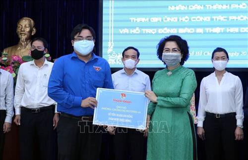 Tiếp nhận tượng trưng số tiền ủng hộ công tác phòng dịch COVID-19 của Thành Đoàn Thành phố Hồ Chí Minh. Ảnh: Xuân Khu-TTXVN