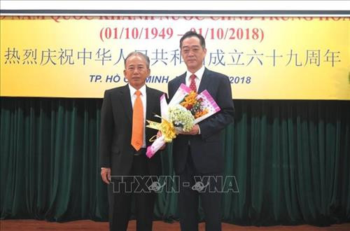 Ông Dương Quan Hà (trái) tặng hoa chúc mừng ông Ngô Tuấn, Tổng lãnh sự nước CHND Trung Hoa tại Thành phố Hồ Chí Minh, trong buổi họp mặt kỷ niệm. Ảnh: Xuân Khu-TTXVN