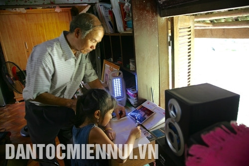 Ngoài thời gian làm công tác xã hội, ông Hoàng Đình Thìn cần mẫn dạy con cháu học hành. Ảnh: Phan Ngọc Đức