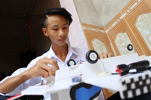 Em Ưng Sĩ Sơn lắp ráp mô hình máy bay chiến đấu Su-37. Ảnh: Tùng Lâm- TTXVN Em Ưng Sĩ Sơn lắp ráp mô hình máy bay chiến đấu Su-37. Ảnh: Tùng Lâm- TTXVN