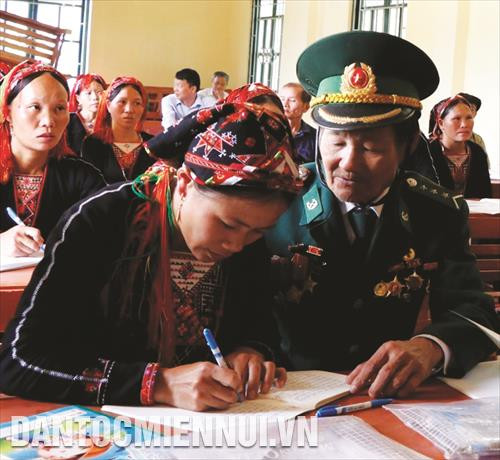 Cựu chiến binh Đỗ Minh Bản hướng dẫn bà con dân tộc thiểu số viết chữ Cựu chiến binh Đỗ Minh Bản hướng dẫn bà con dân tộc thiểu số viết chữ