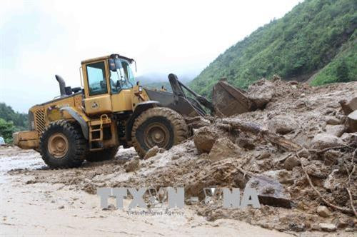 Máy móc san gạt bùn, đất đá bị sạt lở tại km75, Quốc lộ 4D từ Lai Châu đi Lào Cai. Ảnh: Quý Trung – TTXVN Máy móc san gạt bùn, đất đá bị sạt lở tại km75, Quốc lộ 4D từ Lai Châu đi Lào Cai. Ảnh: Quý Trung – TTXVN