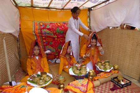 Bà Bóng giúp các thiếu nữ mặc trang phục truyền thống trước khi làm lễ.