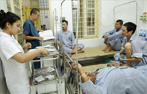 Nhân viên y tế chăm sóc điều trị cho người bệnh mắc sốt xuất huyết . Ảnh: Dương Ngọc – TTXVN.