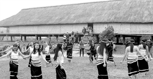 Các thiếu nữ múa ka đấu bên nhà dài của người Co. Ảnh: baoquangnam.vn Các thiếu nữ múa ka đấu bên nhà dài của người Co. Ảnh: baoquangnam.vn