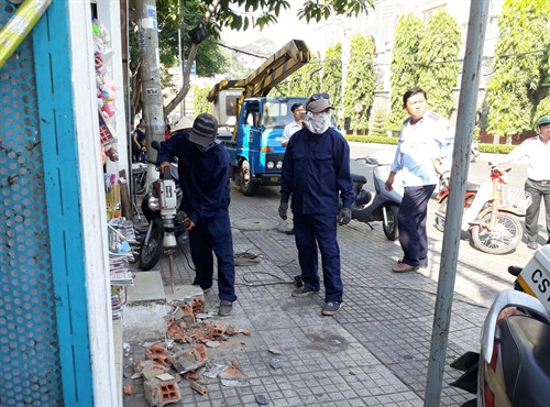 Lực lượng chức năng xử lý những công trình sai phạm. Ảnh : Huyền Trang - TTXVN Lực lượng chức năng xử lý những công trình sai phạm. Ảnh : Huyền Trang - TTXVN