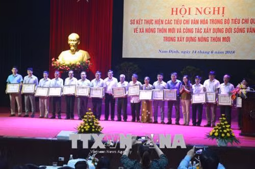 Trao Bằng khen cho các tập thể và cá nhân có thành tích xuất sắc trong việc thực hiện các tiêu chí văn hoá trong Bộ tiêu chí quốc gia về xã nông thôn mới. Ảnh: Công Luật - TTXVN