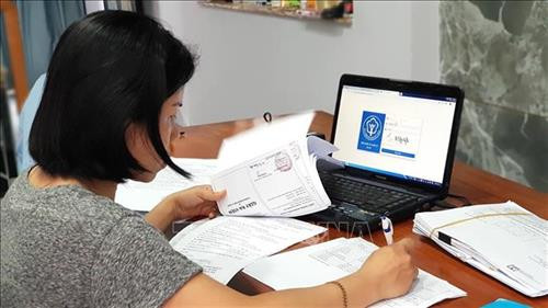 Nhân viên BHXH Thành phố Hồ Chí Minh làm việc tại nhà qua cổng dịch vụ công trực tuyến của thành phố. Ảnh: Trần Xuân Tình - TTXVN