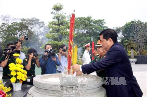Bí thư Thành ủy TP.HCM Đinh La Thăng và Chính ủy Quân khu 7 thắp hương tưởng niệm các AHLS tại nghĩa trang liệt sĩ Thành phố. Ảnh: Thanh Vũ-TTXVN