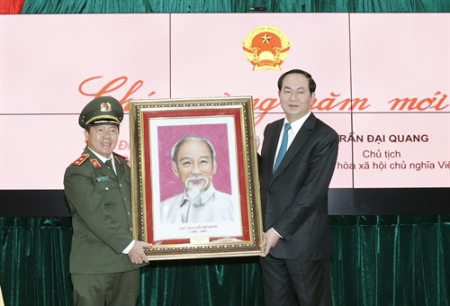 Chủ tịch nước Trần Đại Quang tặng bức tranh chân dung Chủ tịch Hồ Chí Minh cho cán bộ, chiến sĩ Cục An ninh mạng. Ảnh: Nhan Sáng-TTXVN