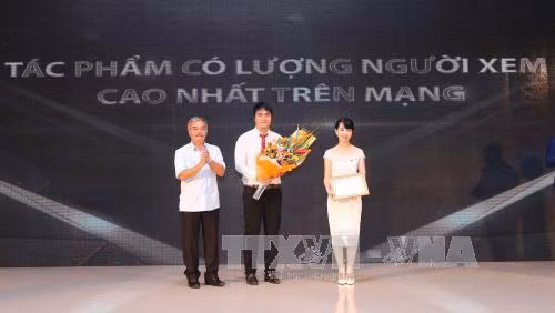 Ông Nguyễn Hoài Dương, Phó Tổng Giám đốc Thông tấn xã Việt Nam trao giải Tác phẩm có lượng người xem cao nhất trên mạng. Ảnh: Danh Lam – TTXVN