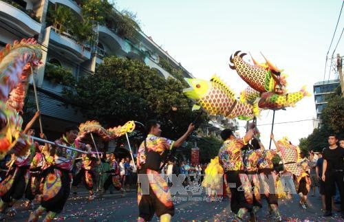 Các đoàn lân, sư, rồng biểu diễn qua các đường phố lớn của Quận 5. Ảnh: Phương Vy - TTXVN