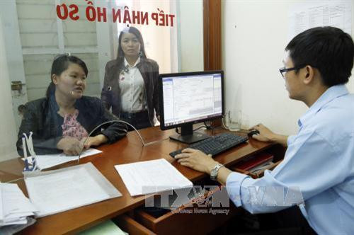 Khách hàng giao dịch tại bộ phận Một cửa - BHXH huyện Đăk Đoa (Gia Lai). Ảnh: Dương Ngọc - TTXVN Khách hàng giao dịch tại bộ phận Một cửa - BHXH huyện Đăk Đoa (Gia Lai). Ảnh: Dương Ngọc - TTXVN