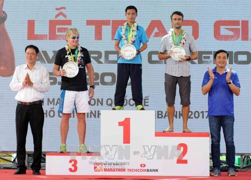 Ban tổ chức trao phần thưởng cho các vận động viên nữ đạt thứ hạng cao ở cự ly 21km. Ảnh: An Hiếu – TTXVN