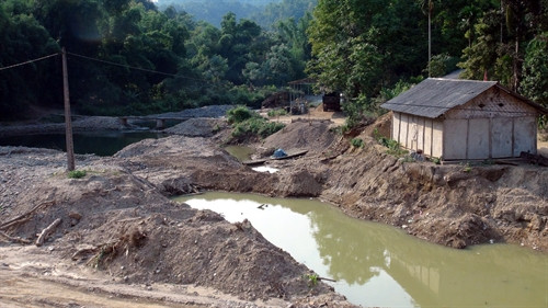 Những ngôi nhà nằm lọt thỏm giữa những núi đất, mưa to có thể gây ngập lụt bất cứ lúc nào. Những ngôi nhà nằm lọt thỏm giữa những núi đất, mưa to có thể gây ngập lụt bất cứ lúc nào.