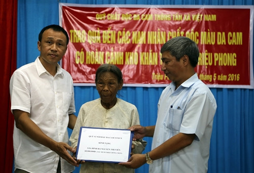Ông Nguyễn Thế Sơn (ngoài cùng bên phải), Giám đốc Quỹ Vì nỗi đau da cam TTXVN cùng nhà tài trợ tặng nhà tình nghĩa cho bà Nguyễn Thị Viên, xã Triệu Trung, huyện Triệu Phong. Ảnh: Trần Tĩnh – TTXVN