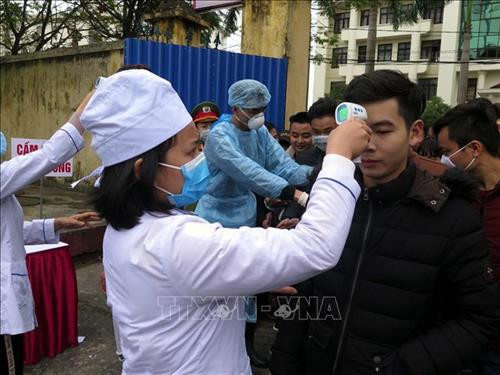 Lực lượng y tế kiểm tra thân nhiệt của người dân Thái Nguyên tại Lễ giao nhận quân năm 2020. Ảnh: Thu Hăng-TTXVN