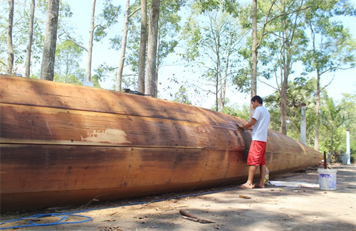 Thực hiện công đoạn "trét chay" thân ghe Ngo