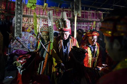 Kết thúc nghi lễ này mỗi thầy cúng dùng hai chiếc gậy làm phép nâng học trò đứng dậy. Ảnh: laodong.vn