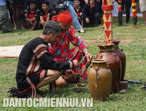 Thầy cúng và già làng lấy rượu để cúng thần linh. Ảnh: H.Hải