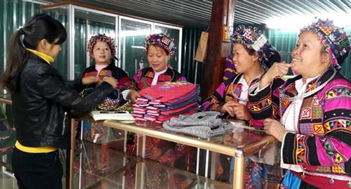 Các thành viên Nhóm dệt thổ cẩm Lô Lô giới thiệu sản phẩm với du khách.