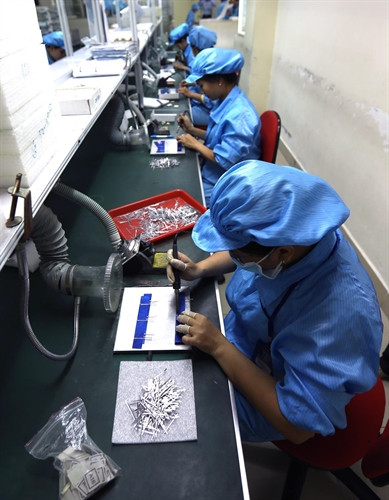 Hoạt động sản xuất pin năng lượng mặt trời xuất khẩu tại Công ty Cổ phần năng lượng mặt trời đỏ tại Khu công nghiệp Đức Hòa. Ảnh: Vũ Sinh – TTXVN