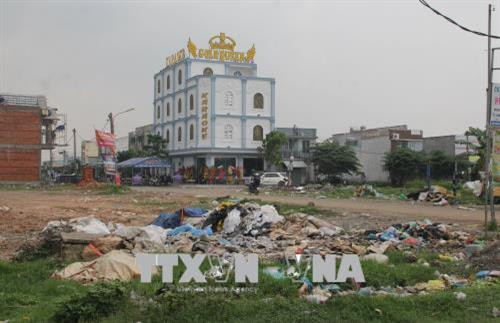 Bãi rác lộ thiên bên lề đường ở ấp Bình Tiền 2, xã Đức Hòa Hạ, Đức Hòa. Ảnh: Bùi Giang - TTXVN