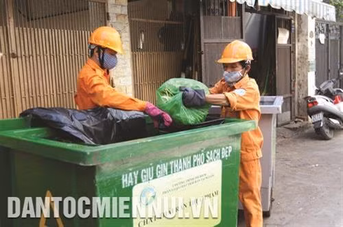 Công nhân Công ty dịch vụ công ích Quận 1 thực hiện thu gom rác đã được phân loại tại nguồn. Ảnh: Thanh Vũ