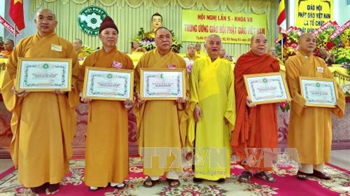 Đại diện các tập thể hoàn thành xuất sắc công tác Phật sự, tích cực xây dựng, phát triển bền vững GHPGVN trong 35 năm qua đón nhận bằng tuyên dương công đức của Trung ương GHPGVN, tại hội nghị. Ảnh: Thế Anh-TTXVN