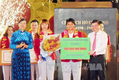 Chủ tịch UBND TP. Hồ Chí Minh Nguyễn Thành Phong tặng bảng tượng trưng 500 triệu đồng cho Đội tuyển bóng đá nữ Việt Nam vì đã có thành tích xuất sắc tại SEA Games 29. Ảnh: Mạnh Linh-TTXVN