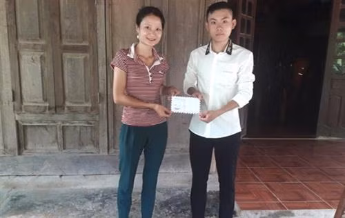 Đại diện UBND xã Tà Cạ khen thưởng cho bạn Lương Thế Mạnh vì đã có hành động dũng cảm cứu người trong nước lũ. Ảnh: msn.com