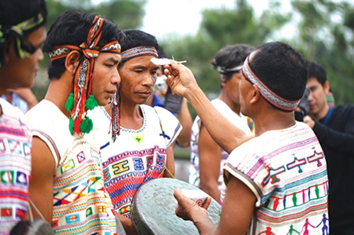 Già làng quệt máu của con vật hiến sinh lên trán dân làng kèm những lời cầu mong có sức khoẻ dồi dào và gia đình hạnh phúc tới thần linh.