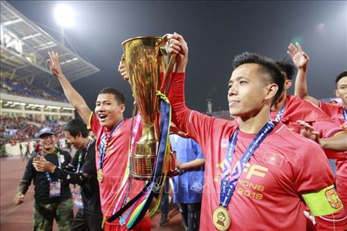 Văn Quyết, Anh Đức cùng chiếc cúp vô địch AFF Suzuki Cup 2018 đi quanh sân vận động Mỹ Đình, chia vui và cám ơn người hâm mộ. Ảnh: Trọng Đạt – TTXVN