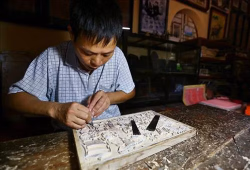 Sáng tác mẫu tranh và khắc ván là khâu sáng tạo quan trọng nhất của quy trình làm tranh Đông Hồ, quyết định sự sinh tồn của một làng tranh, đòi hỏi năng khiếu bẩm sinh và kỹ năng lao động cao ở các nghệ nhân. Ảnh: Minh Quyết – TTXVN