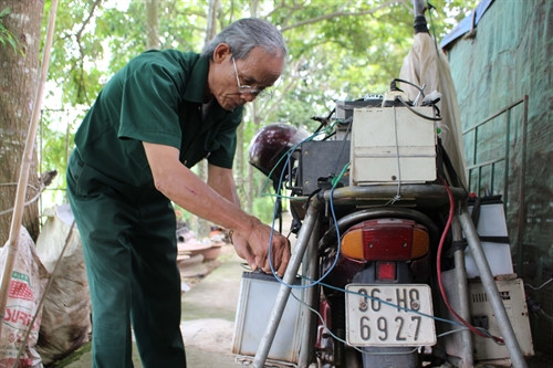 Ông Phạm Ngọc Chiêng kiểm tra thiết bị chuẩn bị đi tuyên truyền.