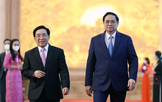 Thủ tướng Phạm Minh Chính và Thủ tướng Lào Phankham Viphavanh dự Lễ phát động Năm Đoàn kết Hữu nghị Việt Nam - Lào, Lào - Việt Nam 2022. Ảnh: Dương Giang-TTXVN Thủ tướng Việt Nam và Thủ tướng Lào đồng chủ trì Lễ phát động Năm Đoàn kết Hữu nghị Việt Nam-Lào, Lào-Việt Nam 2022 ảnh 1