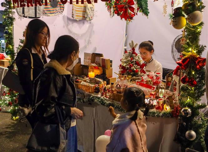 Khách tham quan mua đồ Giáng sinh tại Phiên chợ. Ảnh: Trần Lê Lâm - TTXVN Đà Nẵng lần đầu tiên tổ chức Phiên chợ Giáng sinh ảnh 3