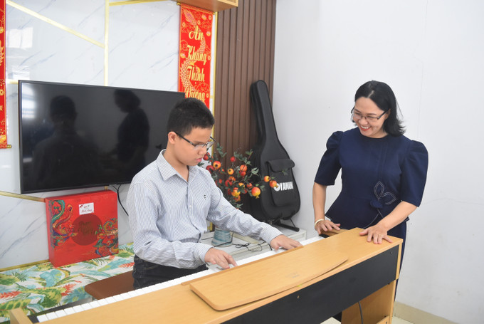 Em Nguyễn Vũ Duy Anh tập đàn tại nhà cùng mẹ. Ảnh: Nguyên Dung – TTTXN daklak2.jpg