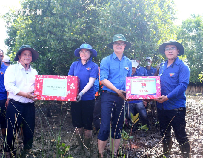 Bí thư thứ nhất Trung ương Đoàn Bùi Quang Huy (thứ 2 từ phải sang) cùng lãnh đạo tỉnh tặng quà cho các đội thanh niên tình nguyện tại huyện Tuy Phước. Ảnh: TTXVN phát vna_potal_bi_thu_thu_nhat_trung_uong_doan_bui_quang_huy_lam_viec_tai_binh_dinh_7520692.jpg