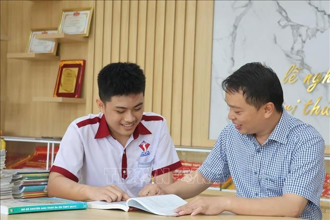 Giáo viên Trường THCS - THPT Đông Du (phường Tân An, tỉnh Đắk Lắk) hướng dẫn học sinh học tập. Ảnh: TTXVN phát gd-daklak1.jpg