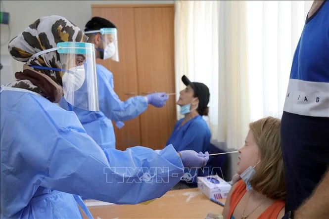 Nhân viên y tế lấy mẫu xét nghiệm COVID-19 tại Or Yehuda, Israel, ngày 22/7/2020. Ảnh: THX/TTXVN 
