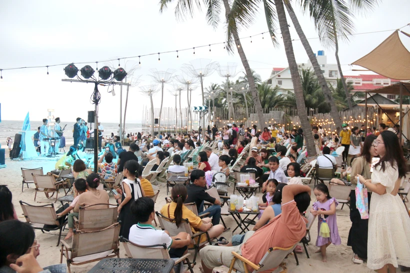 Du khách thưởng thức âm nhạc tại bãi biển ở thành phố Phan Thiết (Bình Thuận). Ảnh: Nguyễn Thanh - TTXVN