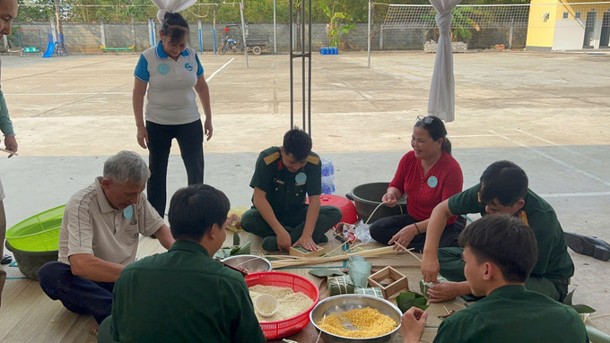 Quân và dân cùng nhau gói bánh chưng tại chương trình. Ảnh: TTXVN phát