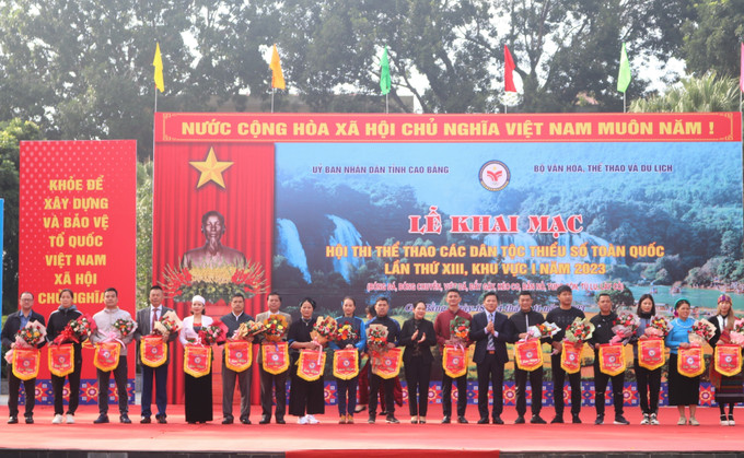 Ban Tổ chức tặng cờ cho các đơn vị tham gia hội thi. Ảnh: Chu Hiệu-TTXVN Khai mạc Hội thi Thể thao các dân tộc thiểu số toàn quốc lần thứ XIII, khu vực I năm 2023 ảnh 3