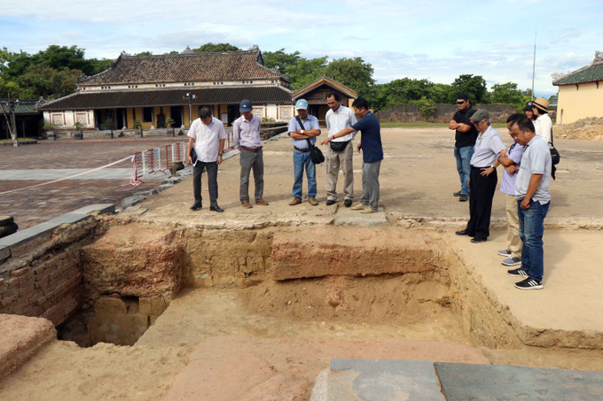 Các nhà khoa học trao đổi về kết quả nghiên cứu nền móng Điện Cần Chánh. Ảnh: Đỗ Trưởng - TTXVN Khai quật khảo cổ học nền Điện Cần Chánh bổ sung cơ sở khoa học cho quá trình phục dựng ảnh 1