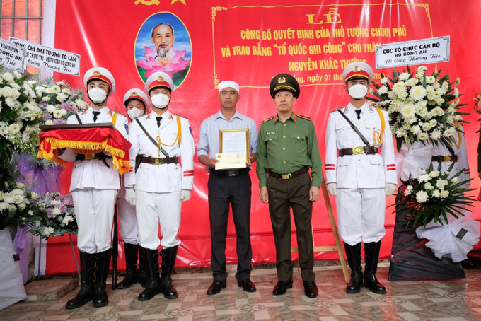 Lãnh đạo Bộ Công an trao quyết định truy thăng cấp bậc hàm cho các liệt sĩ. Ảnh: TTXVN phát Trao Bằng "Tổ quốc ghi công" và Quyết định thăng quân hàm đối với Cảnh sát Giao thông hy sinh trên đèo Bảo Lộc ảnh 2