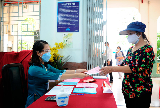 Phát phiếu tận tay cử tri người Hoa tại khu vực bỏ phiếu số 54 ở Trường trung học cơ sở Mạch Kiếm Hùng, phường 11, quận 5, Thành phố Hồ Chí Minh. Cử tri người Hoa quận 5 hân hoan đi bầu cử ảnh 7