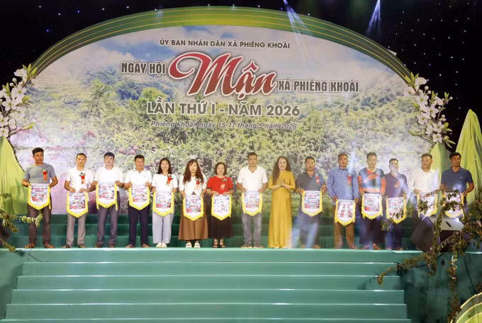 Ban Tổ chức trao cờ lưu niệm cho đại diện các bản, đơn vị trường học, hợp tác xã tham gia Ngày hội.